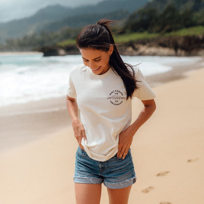 front of woman walking on beach with vintage white t-shirt with mac farms logo on pocket