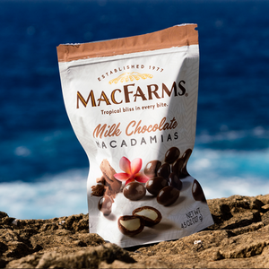 
            
                Load image into Gallery viewer, Milk Chocolate Macadamias on rock with ocean background
            
        